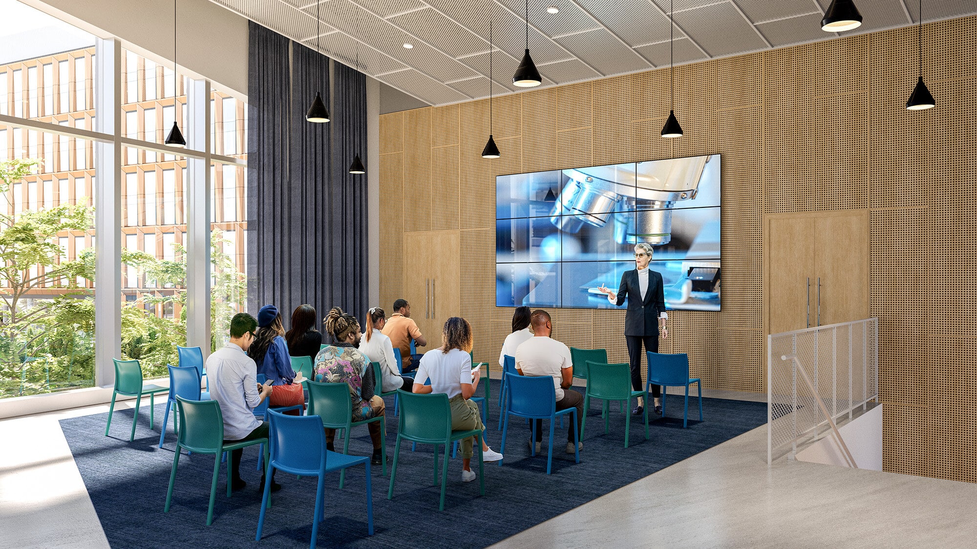 A woman giving a presentation in a large, open concept auditorium