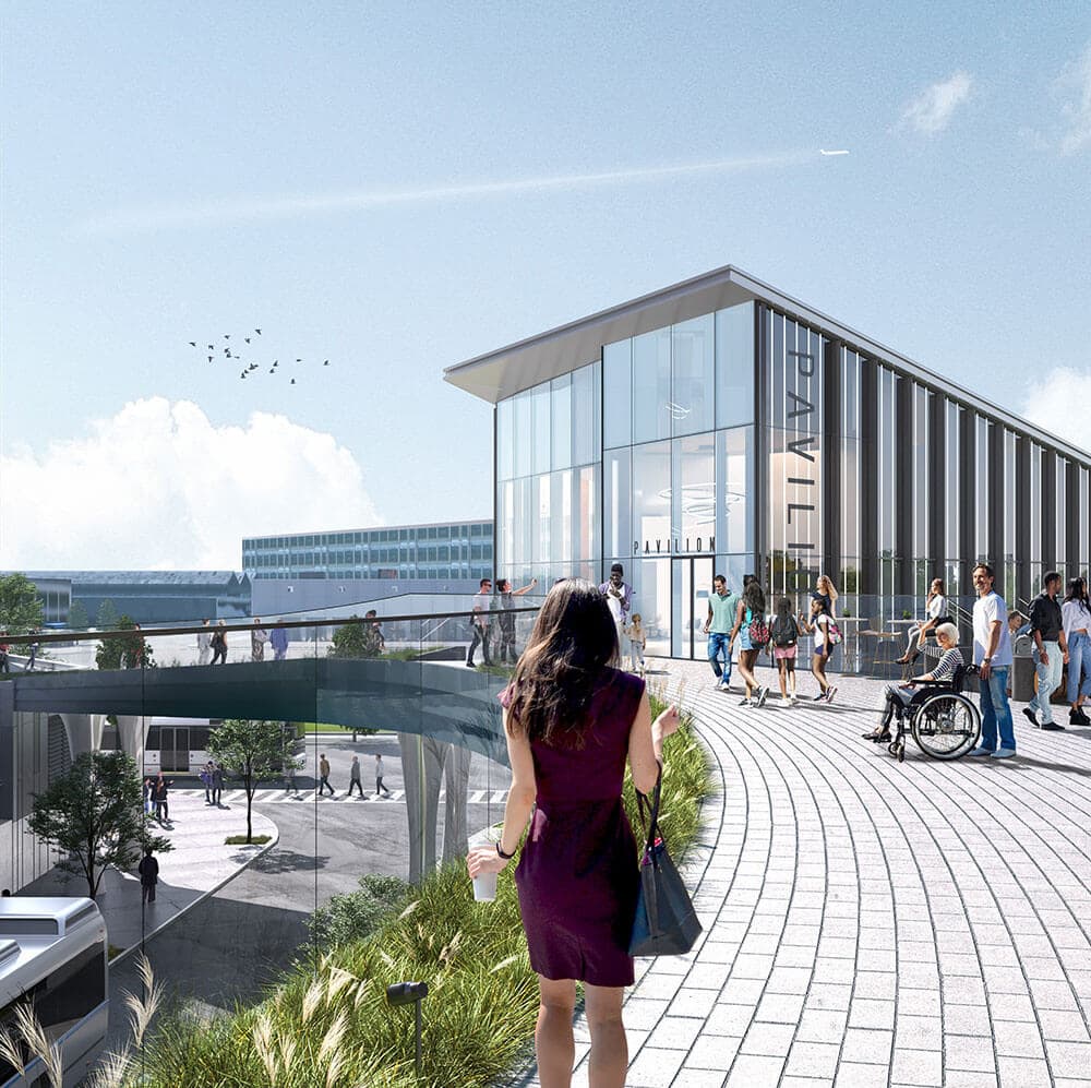 A woman in a purple dress walking across a outside bridge